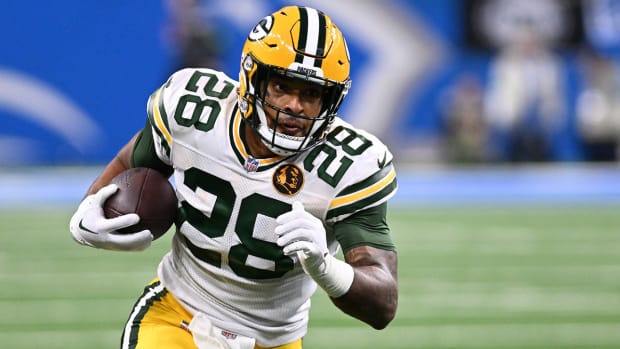 AJ Dillon rushes the football in a game against the Lions.